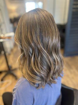 Full head of teasy lights and natural, lived-in highlights for a soft, sun-kissed look.