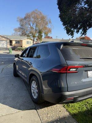 A clean and well-maintained Toyota Grand Highlander used for professional transportation service.