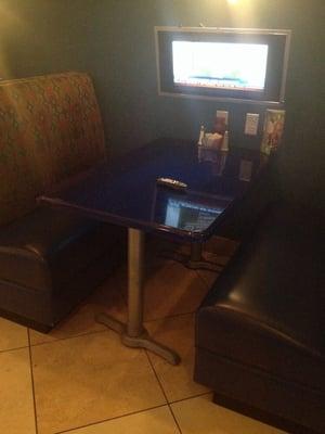 Four booths with their own televisions and remote controls, as well as three bigger screens in the bar playing the game.