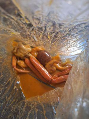 Leftover or unfinished remaining King Crab Legs, potato(es), shrimp, and thinnly cut lime slices.