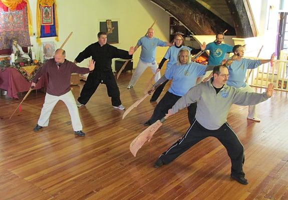 Advance Tai Chi Students practice with traditional weapons like the Guan Dao.
