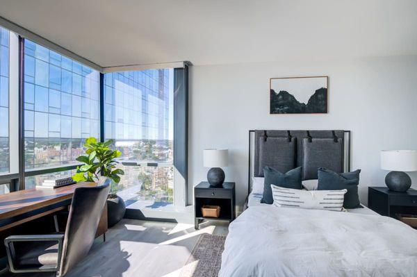The bedroom at Encore Apartments offers a peaceful retreat with beautiful city views.