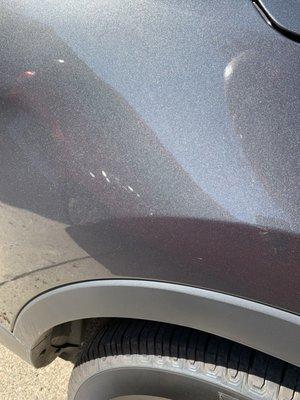 Large scratches along the passenger side of the vehicle