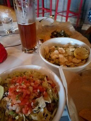 Sweet potato burrito bowl (front), warm brussels sprouts caesar salad (center), sweet potato taco (back)