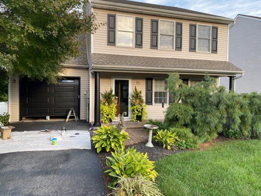 Painted garage doors, and porch pillars along with lighting.