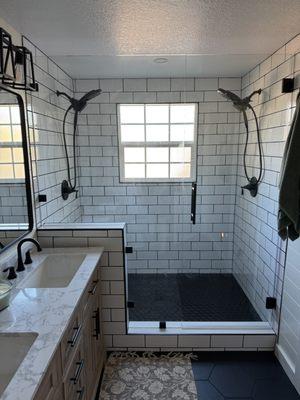 Walk in shower with his/hers rainfall shower heads.