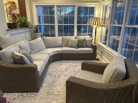 Three-piece sectional sofa with inside wedge, swivel chair, and plenty of throw pillows to match