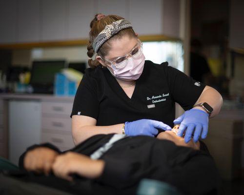 orthodontist working on patient