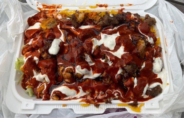 Traditional Halal lamb and chicken over rice with white sauce and a HEAVY DOSE of sinus-cleansing, gut-ripping fiery hot sauce.