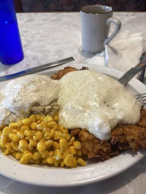 Chicken fried steak mashed potatoes and corn.