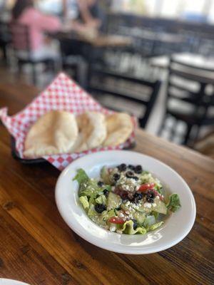 Greek salad, fresh cut salad topped with feta cheese and sliced black olives