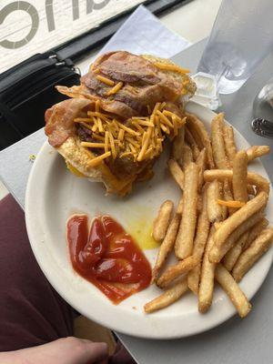 Breakfast sandwich egg over easy cheddar cheese bacon sausage avacado on a hoagie roll sub breakfast potatoes for French fries