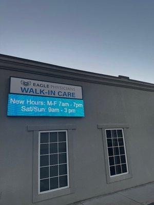 Sign w/new hours.