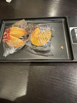 Fortune cookies served on dirty tray that just got dropped off at our table