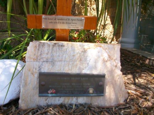 The marble stone sign is enscribed: "IN HONOR TO OUR LADY."