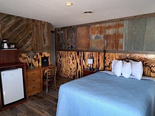 Recently remodeled queen room with hardwood floor, window ac unit and fireplace.