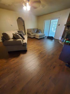 New flooring with my new living room furniture. Flooring: Mohawk Rev Wood Plus Western Row in Red Clay Oak.