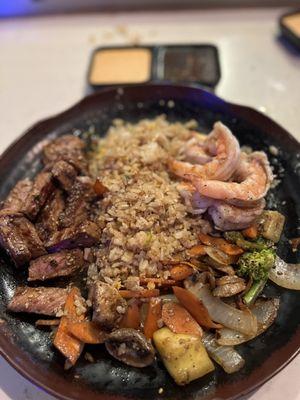Amazing food that consists of steak, shrimp, veggies, and fried rice.