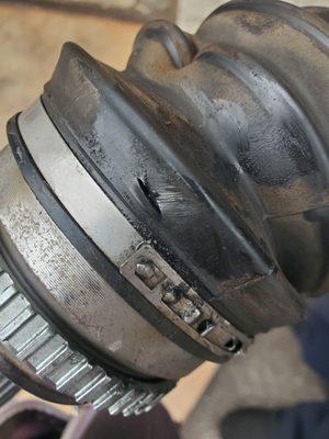 Mechanic or employee put a knife PURPOSELY through the left CV boot.