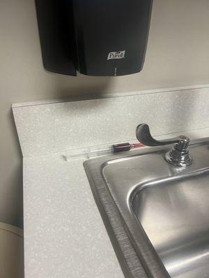 Bloody needle left by nurse in pre op