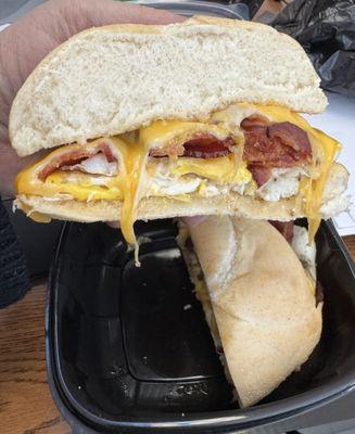 Half of a bacon, egg, and cheese sandwich on a kaiser roll