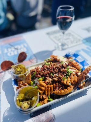 Waffle Fried with bacon, jalapeños, cheese sauce, and green onions