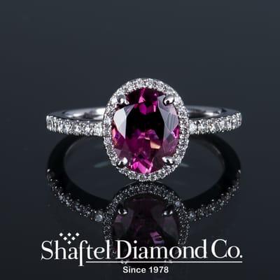 Fine pink tourmaline diamond halo ring.