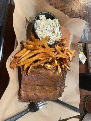 Coleslaw, cornbread, french fries, and ribs