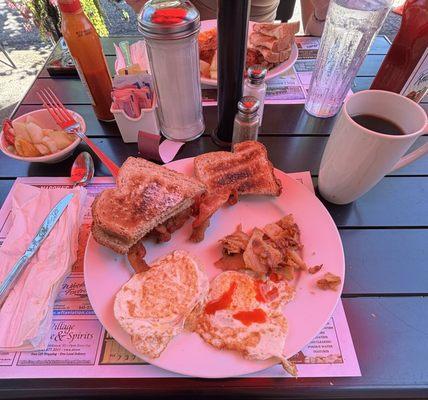 Eggs, bacon, hash browns, whole wheat toast, fruit, and black coffee