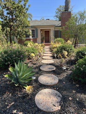 The walkway nestled between agaves and succulents
