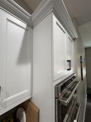 cracking and peeling paint is between door/hinge all the way down into the oven area.