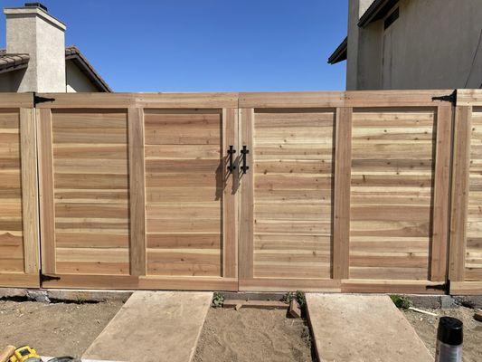 Custom horizontal cedar gate with in-house welded steel frames by Fortress Fence Company, serving Santa Barbara County.