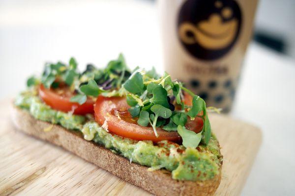 Avocado Toast - Smashed avocado with toasted sesame seeds, vine ripe tomato, microgreens, and lemon zest