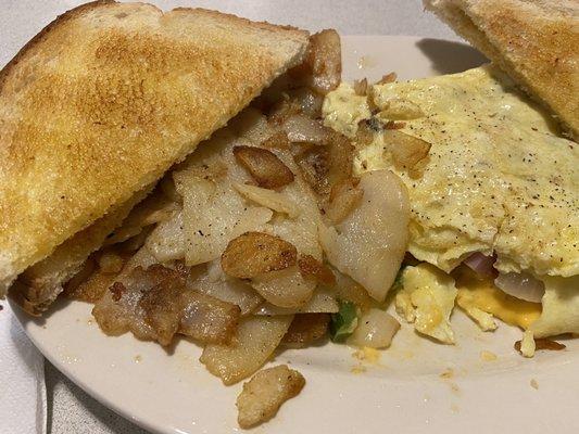 Two egg omelette, side of potatoes and sourdough toast