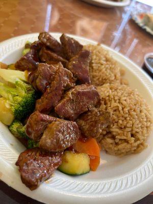 Steak cooked medium with veggies and rice