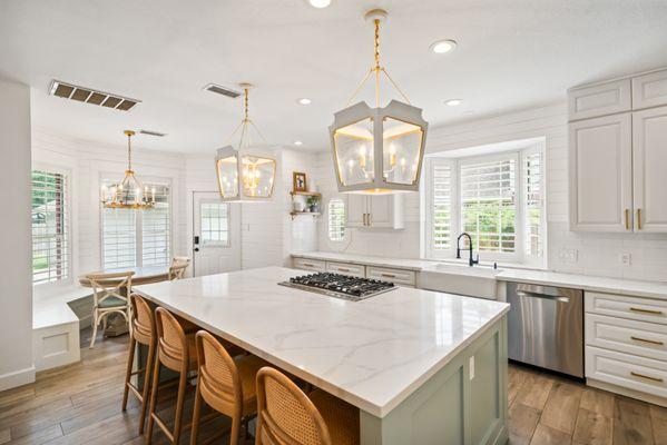 Stylish kitchen with quartz counters, custom cabinetry, and open dining space.