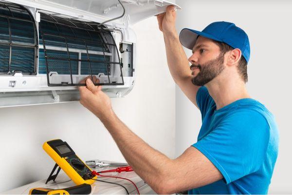 The technician is shown accessing the internal filters and coils, which is the essential step for AC cleaning, preventative m...