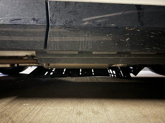 Engine cover underneath car fallin' down