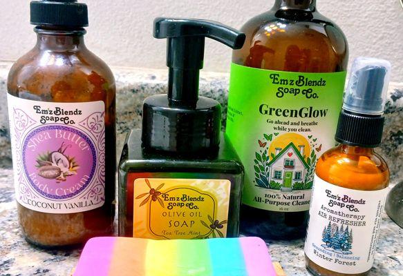 Some of Em'z Blendz products: Shea butter body cream, olive oil soap, GreenGlow cleaning solution, aromatherapy spray, rainbow soap