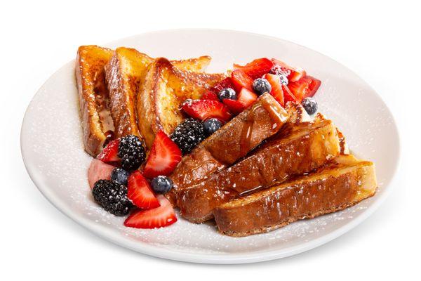Sweet and satisfying! Enjoy fluffy French toast at Rosie's Café, topped with mixed berries, syrup, and a dusting of powdered sugar.