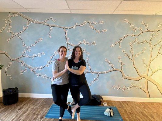 The owner Charla & a friend in our beautiful and peaceful yoga sanctuary with live plants, natural light & wood floors