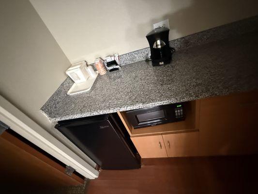 Coffee maker, counter space,ice bucket, mini fridge & freezer, microwave .