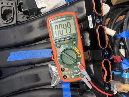 Resistance testing of a wire harness on the Mercury Verado V8 outboard engine.