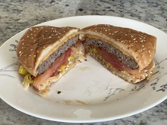 Cheese burger with extra tomato and chopped chilis