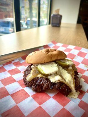 Single smashburger with pickles, grilled onions, and secret sauce.