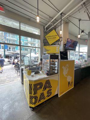 Front of stand as soon as you walk in the front door of the food hall