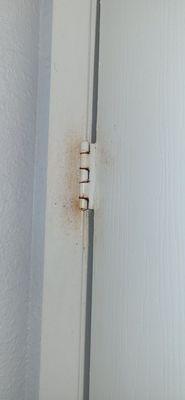 Something on the wall & hinge inside the bathroom. (Room 214)