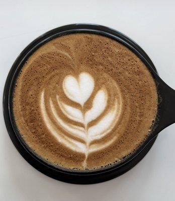 Latte in a black mug