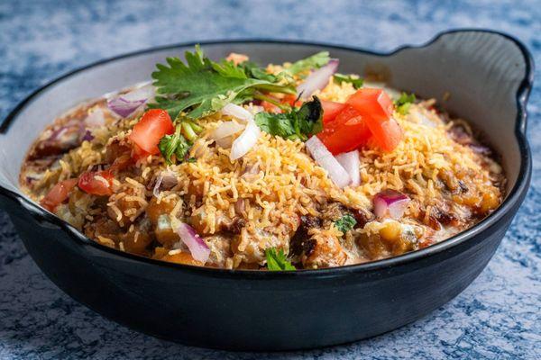 Savor our flavorful Chaat, packed with crispy sev, tangy chutneys, chickpeas, and fresh toppings. A perfect burst of taste in every bite!