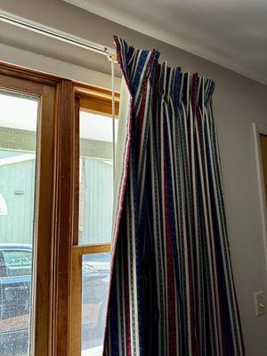 Curtain falling off of broken hooks and no other shade to block full view on room on street level